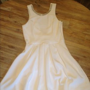 White dress with pearl and rhinestone detailing.